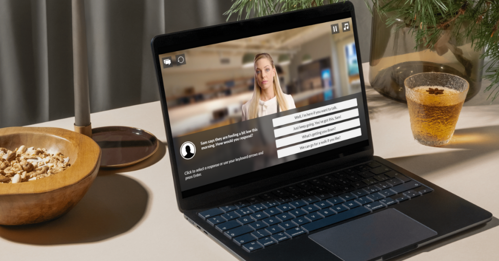 A laptop displaying an AI avatar conversation, with a person on the screen and a series of pre-written response options for the user.