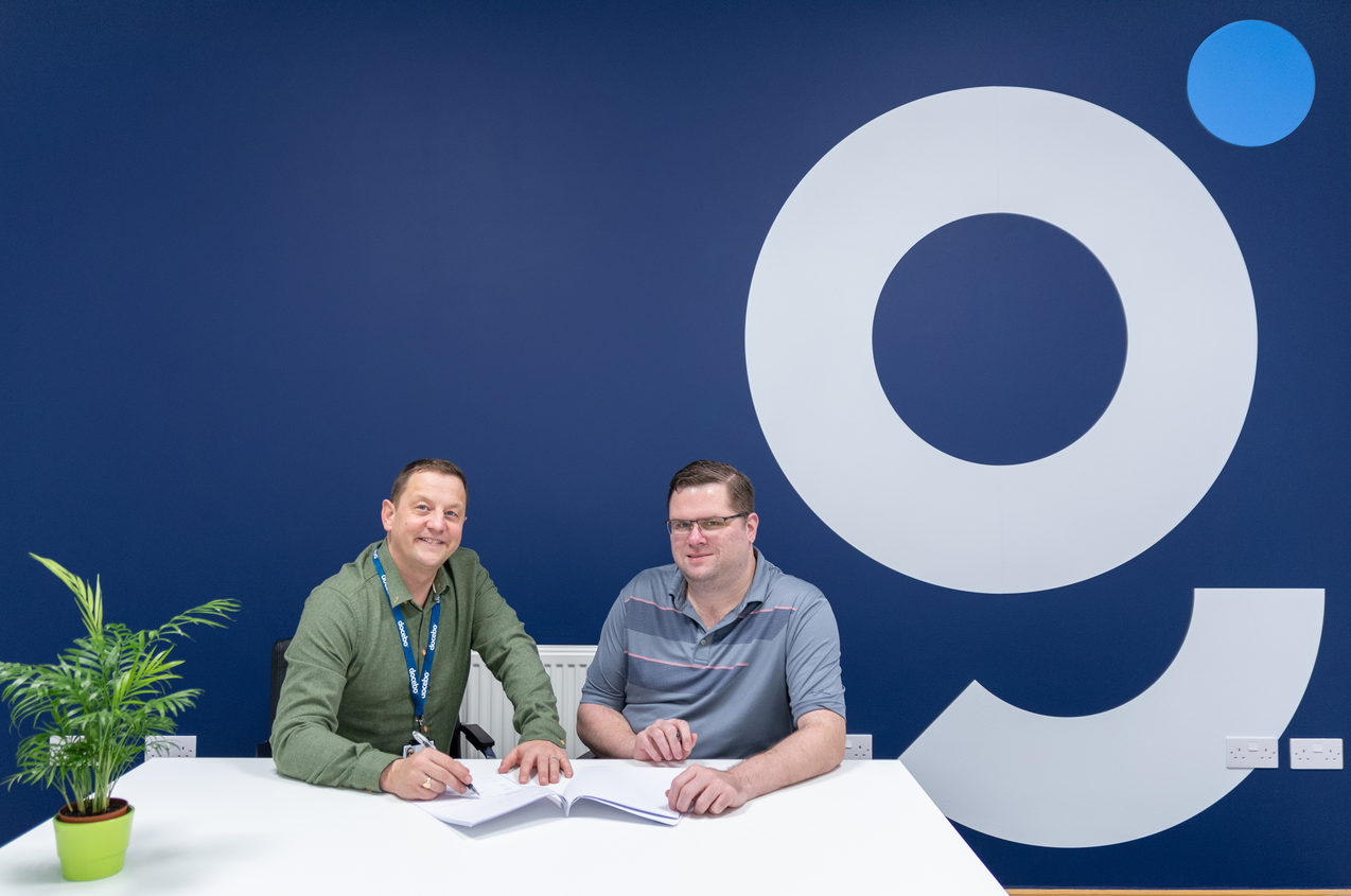 An image of GuyKat founder Guy McEvoy signing the offical joining and opening of a US Guykat branch